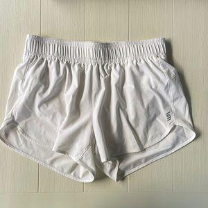 White athletic shorts. Size Medium. Unsure of brand, Logo pictured.